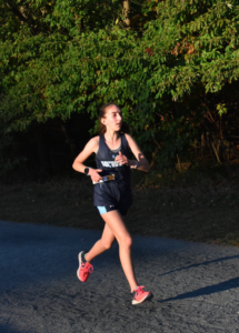 Chloe running in a meet. Source: The Hewitt School